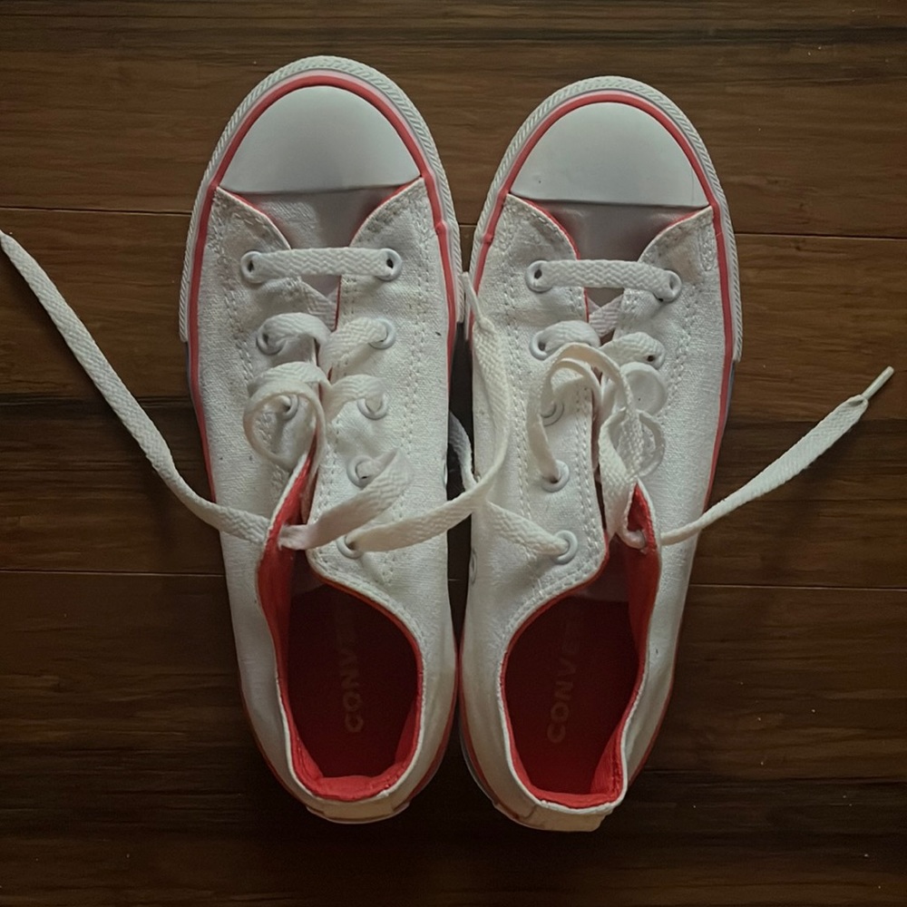 White converse with pink yellow and blue trim.